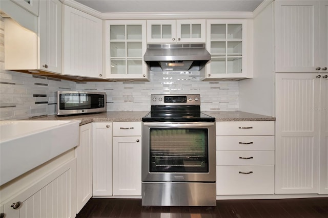 2363 Milford Cir, Sarasota, FL 34239 - kitchen with stainless steel appliances, under cabinet range hood, white cabinets, backsplash, and glass insert cabinets