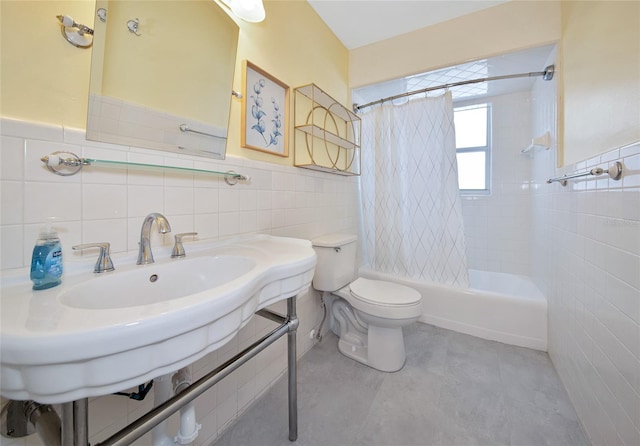 2363 Milford Cir, Sarasota, FL 34239 - bathroom featuring tile walls, toilet, shower / bath combo with shower curtain, and a wainscoted wall