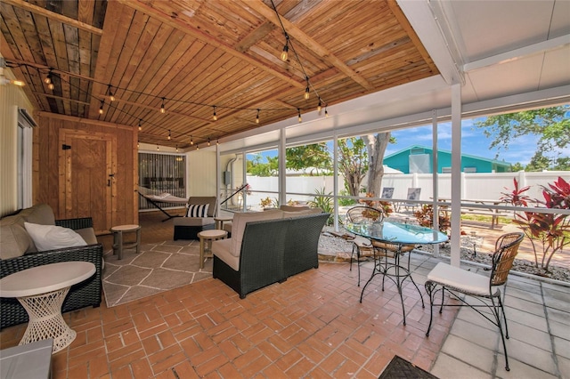 2363 Milford Cir, Sarasota, FL 34239 - sunroom featuring track lighting, healthy amount of natural light, and outdoor dining space