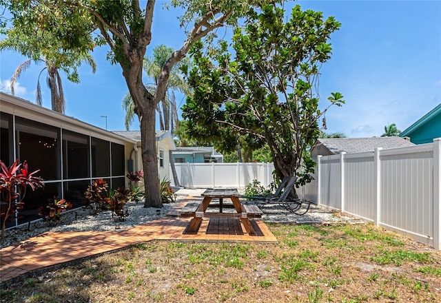 2363 Milford Cir, Sarasota, FL 34239 - fenced backyard with a sunroom