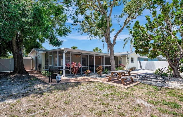 2363 Milford Cir, Sarasota, FL 34239 - back of property with a patio area, a fenced backyard, and a sunroom