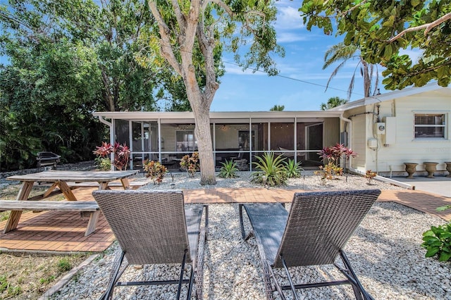 2363 Milford Cir, Sarasota, FL 34239 - back of house featuring a sunroom, a patio, and outdoor dining space