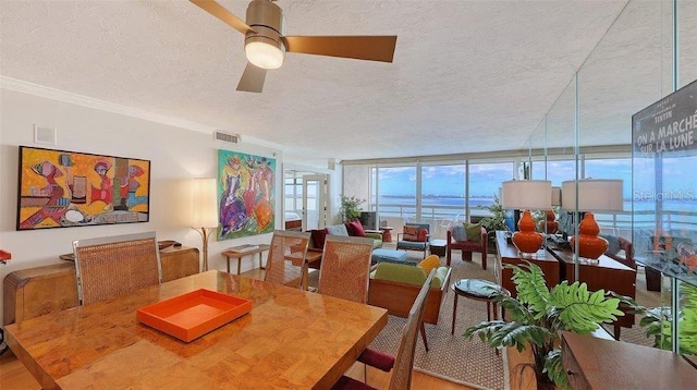 988 Blvd Of The Arts Unit 1016, Sarasota, FL 34236 - dining area featuring a textured ceiling, ceiling fan, and crown molding