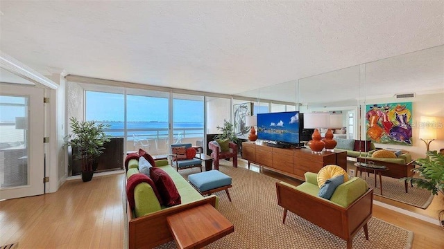988 Blvd Of The Arts Unit 1016, Sarasota, FL 34236 - living area with light wood-style flooring and a textured ceiling