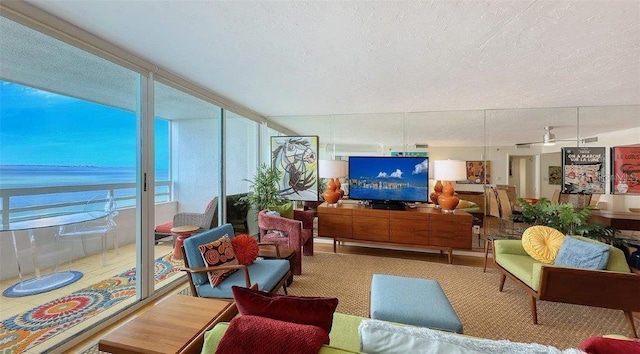 988 Blvd Of The Arts Unit 1016, Sarasota, FL 34236 - living area featuring a textured ceiling and a water view