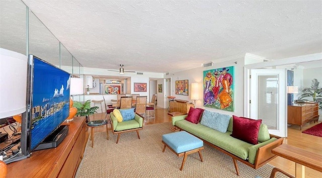 988 Blvd Of The Arts Unit 1016, Sarasota, FL 34236 - living area with light wood finished floors, a textured ceiling, and crown molding