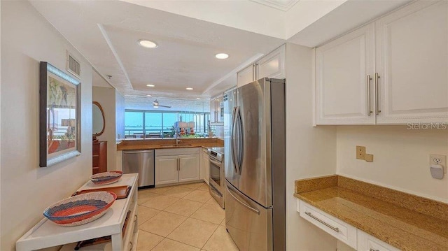 988 Blvd Of The Arts Unit 1016, Sarasota, FL 34236 - kitchen featuring stainless steel appliances, recessed lighting, light tile patterned floors, white cabinetry, and a sink