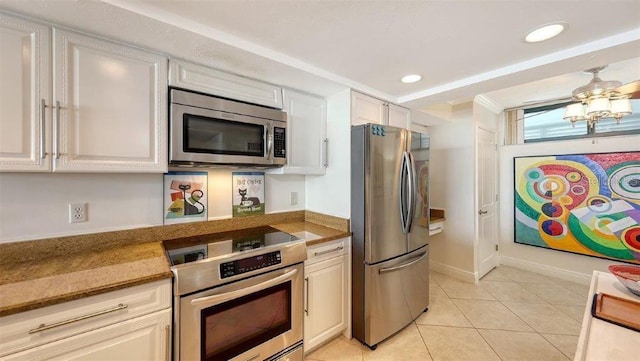 988 Blvd Of The Arts Unit 1016, Sarasota, FL 34236 - kitchen with appliances with stainless steel finishes, light tile patterned floors, recessed lighting, and white cabinetry