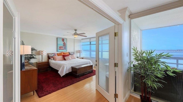988 Blvd Of The Arts Unit 1016, Sarasota, FL 34236 - bedroom featuring light wood finished floors, a ceiling fan, and crown molding