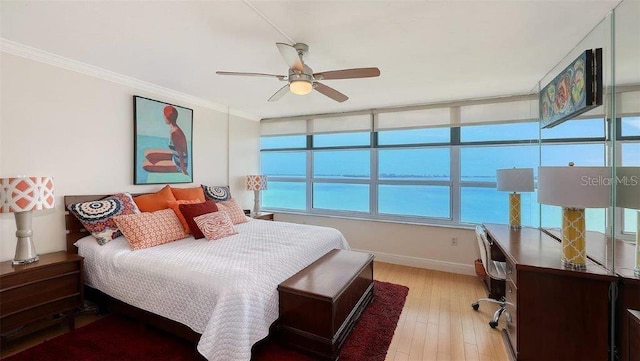 988 Blvd Of The Arts Unit 1016, Sarasota, FL 34236 - bedroom featuring a desk, light wood finished floors, crown molding, baseboards, and a ceiling fan