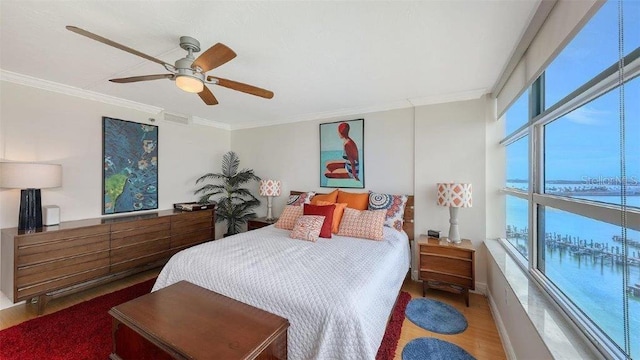 988 Blvd Of The Arts Unit 1016, Sarasota, FL 34236 - bedroom featuring crown molding, wood finished floors, a ceiling fan, and a water view