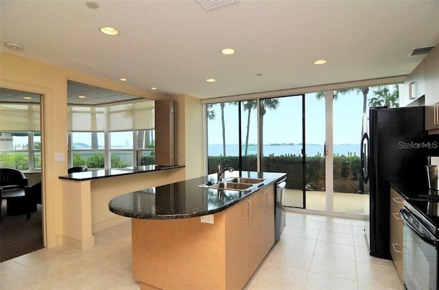 988 Blvd Of The Arts Unit 1016, Sarasota, FL 34236 - kitchen featuring a sink, stove, dishwasher, recessed lighting, and an island with sink