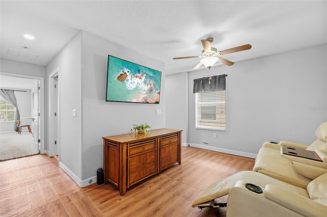 1234 Harbour Blue St, Ruskin, FL 33570 - living room with a ceiling fan, light wood-style floors, and baseboards