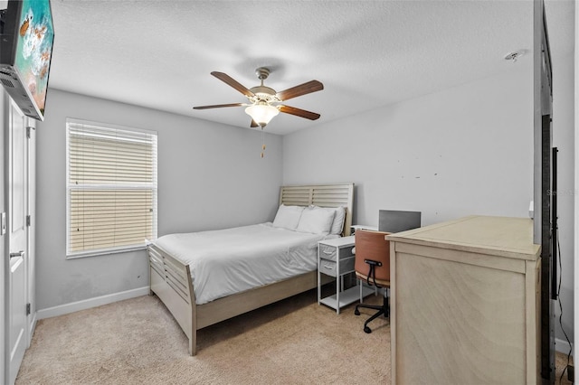 1234 Harbour Blue St, Ruskin, FL 33570 - bedroom with light carpet, baseboards, a textured ceiling, a ceiling fan, and a desk