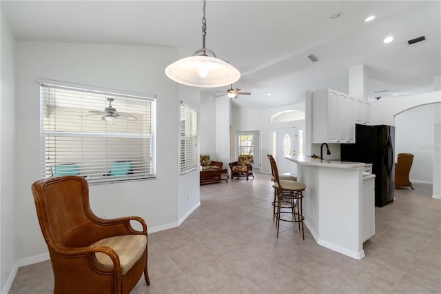 2199 Palm Ct, North Port, FL 34287 - kitchen featuring ceiling fan, arched walkways, a breakfast bar, white cabinets, and recessed lighting
