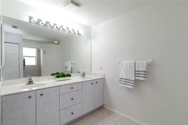 2199 Palm Ct, North Port, FL 34287 - bathroom with double vanity, tile patterned floors, and baseboards