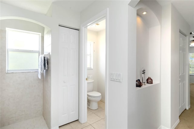 2199 Palm Ct, North Port, FL 34287 - full bathroom featuring a closet, toilet, tiled shower, and tile patterned flooring