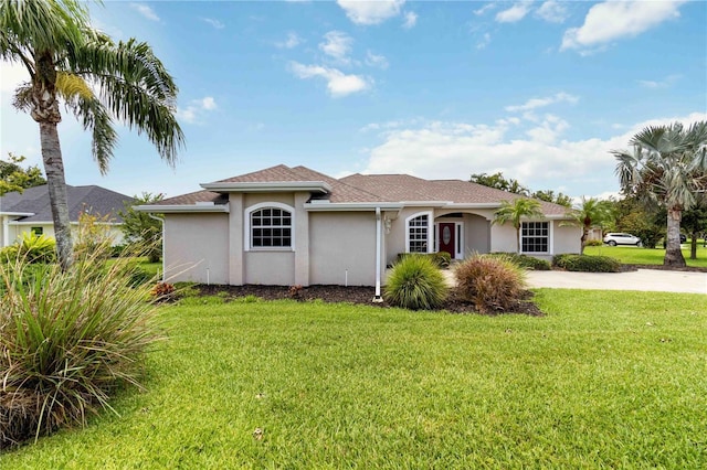 2199 Palm Ct, North Port, FL 34287 - view of front facade with stucco siding and a front yard