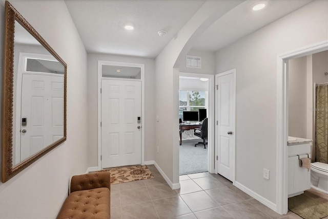 2105 Grand Flora Trl, Bradenton, FL 34208 - foyer entrance with arched walkways, light tile patterned floors, baseboards, and recessed lighting