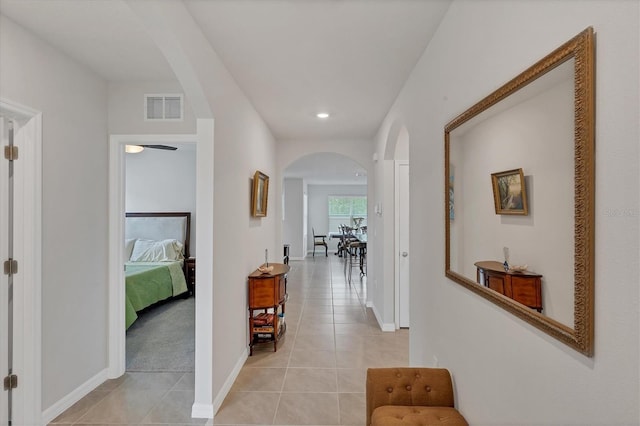 2105 Grand Flora Trl, Bradenton, FL 34208 - corridor featuring arched walkways, light tile patterned floors, baseboards, and recessed lighting