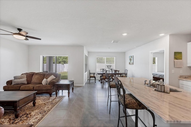 2105 Grand Flora Trl, Bradenton, FL 34208 - tiled living room featuring a sink, plenty of natural light, a ceiling fan, and recessed lighting