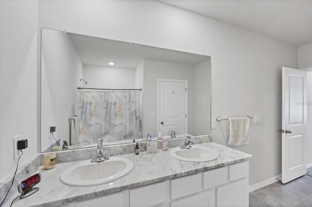 2105 Grand Flora Trl, Bradenton, FL 34208 - full bath with double vanity, tile patterned floors, and a shower with shower curtain