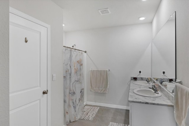 2105 Grand Flora Trl, Bradenton, FL 34208 - bathroom with double vanity, tile patterned flooring, baseboards, curtained shower, and recessed lighting