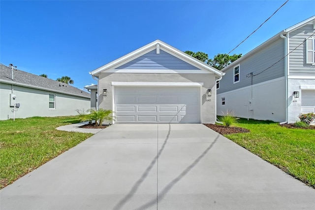 1643 35th St, Sarasota, FL 34234 - ranch-style house with a front yard, concrete driveway, an attached garage, and stucco siding