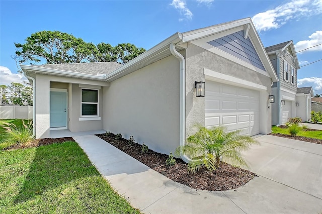 1643 35th St, Sarasota, FL 34234 - view of front of property featuring an attached garage, stucco siding, and driveway