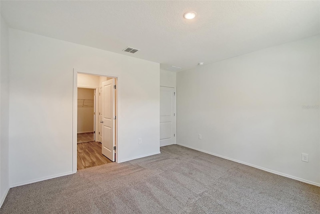 1643 35th St, Sarasota, FL 34234 - unfurnished bedroom with carpet flooring, baseboards, and a spacious closet