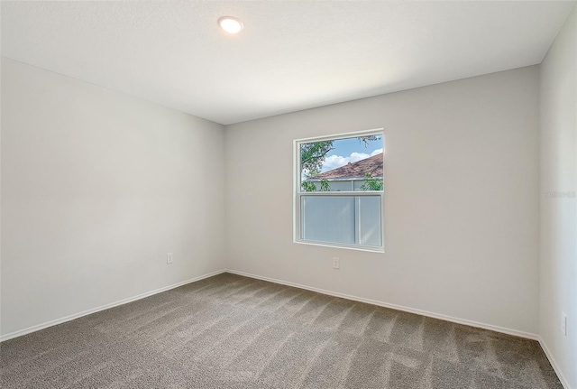 1643 35th St, Sarasota, FL 34234 - empty room featuring carpet and baseboards