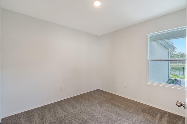 1643 35th St, Sarasota, FL 34234 - unfurnished room featuring dark colored carpet and baseboards