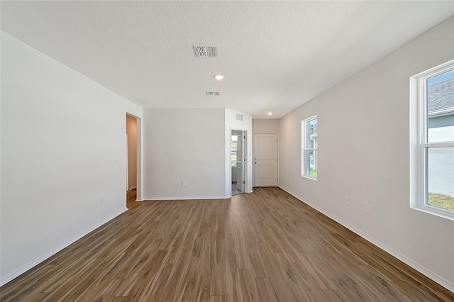 1643 35th St, Sarasota, FL 34234 - empty room featuring wood finished floors, baseboards, and recessed lighting
