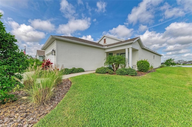 4625 Canoe Creek Ave, Parrish, FL 34219 - view of side of home featuring a garage, a yard, and stucco siding