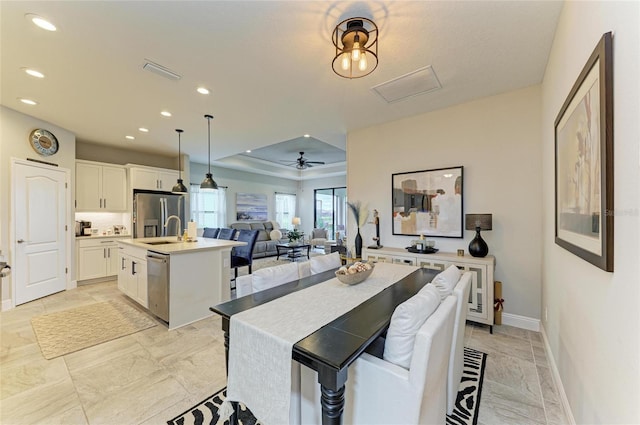 4625 Canoe Creek Ave, Parrish, FL 34219 - kitchen with stainless steel appliances, baseboards, an island with sink, white cabinets, and recessed lighting