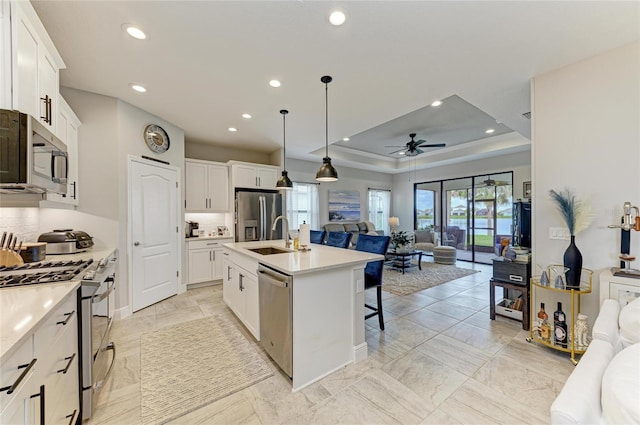 4625 Canoe Creek Ave, Parrish, FL 34219 - kitchen with appliances with stainless steel finishes, open floor plan, recessed lighting, a ceiling fan, and tasteful backsplash