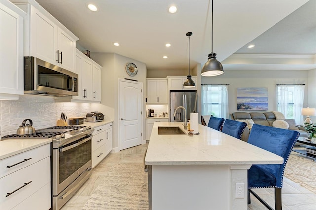 4625 Canoe Creek Ave, Parrish, FL 34219 - kitchen featuring stainless steel appliances, open floor plan, recessed lighting, a sink, and backsplash