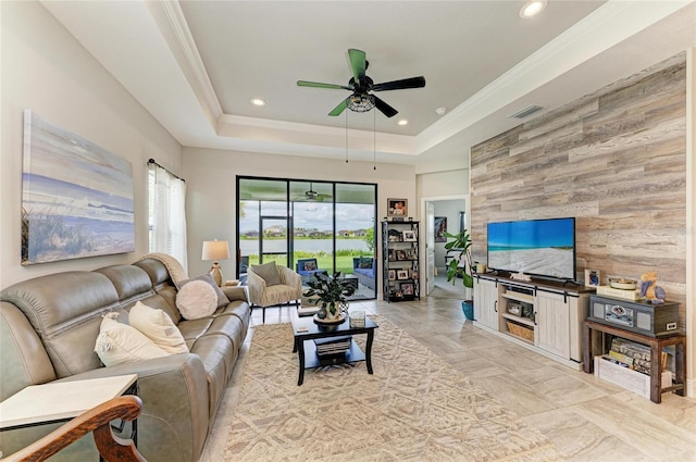 4625 Canoe Creek Ave, Parrish, FL 34219 - living area with wood walls, ceiling fan, a tray ceiling, recessed lighting, and an accent wall
