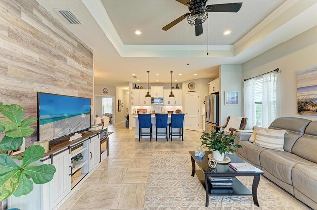4625 Canoe Creek Ave, Parrish, FL 34219 - living area featuring ceiling fan, wooden walls, a raised ceiling, recessed lighting, and ornamental molding