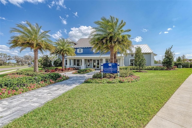 4625 Canoe Creek Ave, Parrish, FL 34219 - view of front of property with a front yard, french doors, metal roof, and a standing seam roof