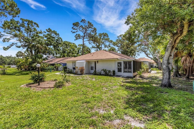 5356 Royal Palm Ave Unit 5356, Sarasota, FL 34234 - back of property featuring a sunroom, stucco siding, and a lawn