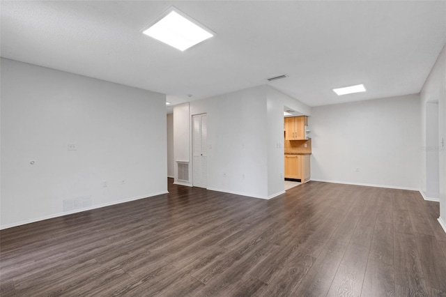 5356 Royal Palm Ave Unit 5356, Sarasota, FL 34234 - unfurnished living room with dark wood-type flooring and baseboards
