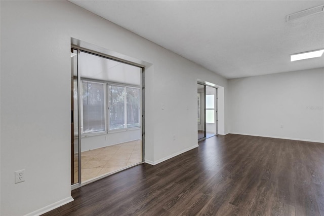 5356 Royal Palm Ave Unit 5356, Sarasota, FL 34234 - unfurnished room featuring plenty of natural light, wood finished floors, and baseboards