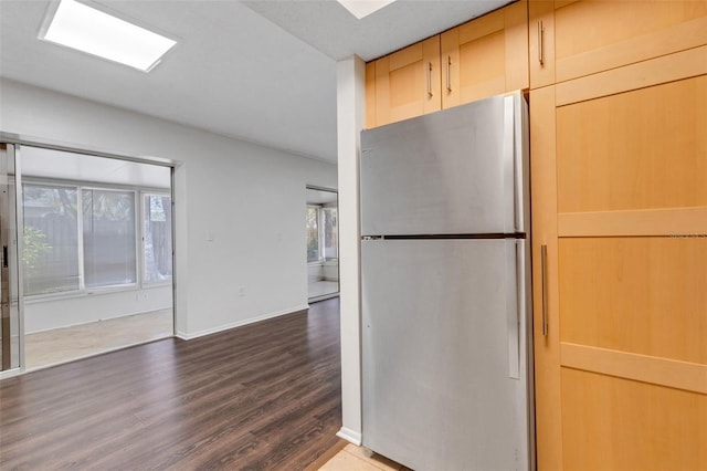 5356 Royal Palm Ave Unit 5356, Sarasota, FL 34234 - kitchen featuring freestanding refrigerator, dark wood-style flooring, and baseboards