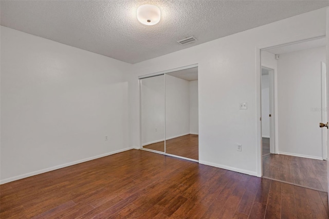 5356 Royal Palm Ave Unit 5356, Sarasota, FL 34234 - unfurnished bedroom with hardwood / wood-style floors, a textured ceiling, a closet, and baseboards