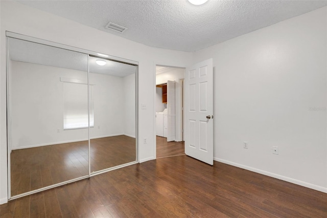 5356 Royal Palm Ave Unit 5356, Sarasota, FL 34234 - unfurnished bedroom featuring hardwood / wood-style flooring, a closet, a textured ceiling, and baseboards
