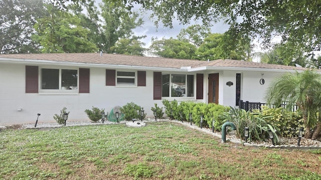 5325 Murdock Ave, Sarasota, FL 34231 - ranch-style home with a front yard, roof with shingles, and concrete block siding