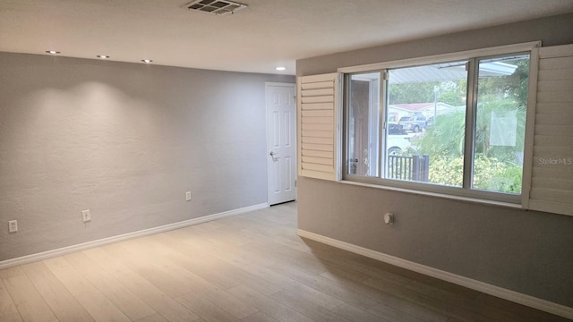 5325 Murdock Ave, Sarasota, FL 34231 - spare room with baseboards, wood finished floors, and recessed lighting