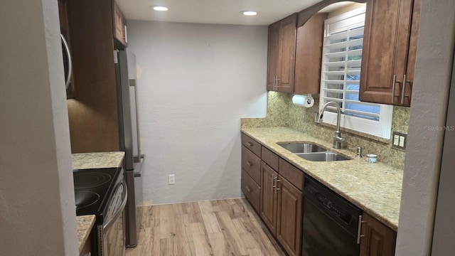 5325 Murdock Ave, Sarasota, FL 34231 - kitchen featuring black dishwasher, range with electric cooktop, a sink, light wood-style floors, and decorative backsplash