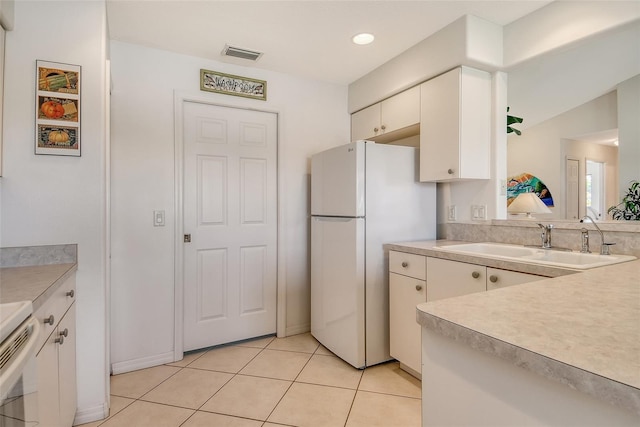 4484 Tortoise Rd, Venice, FL 34293 - kitchen featuring freestanding refrigerator, a sink, light countertops, light tile patterned flooring, and recessed lighting